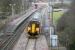 Looking west from the bridge carrying Curriehill Road over the station which reopened in 1987 after closing 36 years earlier. Photograph taken in March 2006 showing a Glasgow Central - Edinburgh Waverley service pulling away from the platform.<br><br>[John Furnevel 07/03/2006]