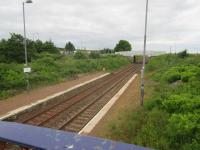 View west from the old footbridge at Breich to the new roadbridge. A ramp runs up from the westbound platform to the bridge and formerly another ran from the eastbound, now overgrown.<br><br>[John Yellowlees 26/06/2017]