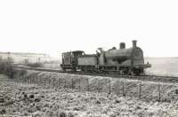 An ex-Caledonian 0-6-0 approaching Dykes Junction, Ayrshire, propelling a brake van on 30 March 1959. The guard appears to be making advance preparations for the next manoeuvre. [Ref query 1650]<br><br>[G H Robin collection by courtesy of the Mitchell Library, Glasgow 30/03/1959]