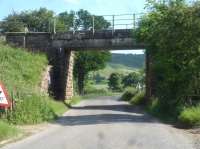 The Esk Valley line to Whitby crosses the River Esk and the local road to Lealholm in rapid succession shortly after leaving Danby Station heading east. The view looking south shows the second bridge, the road bridge, which, for a rural location, has a motorway headroom of 16 feet. The section of the bridge on the far side has a higher still headroom, having been rebuilt in the recent past. The river bridge is some 25m to the right.<br><br>[David Pesterfield 18/06/2017]