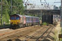 DBC 66054 heads to Kilmarnock with First Great Western coaches from Plymouth on 25 July 2015. Under the road bridge on the right is Euxton Balshaw Lane station.<br><br>[John McIntyre 25/07/2015]