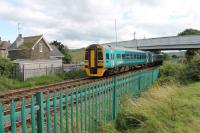 158818 leaves Llandudno heading for the Junction on 26th July 2017. The new bridge in an old style has recently replaced one of similar design, which many years ago replaced a level crossing at this point. The old crossing keeper's cottage seen here is still lived in.   <br><br>[Mark Bartlett 26/07/2017]