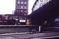 Out on the country end of Paddington station 08944 carries out some shunting in front of the signalbox while 31401 waits under Bishop's Bridge Road to take empty stock west to the carriage sidings.<br><br>[John McIntyre /08/1985]