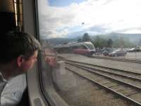An interested passenger looks out at an Andalsnes train at Dombass.<br><br>[John Yellowlees 18/07/2017]