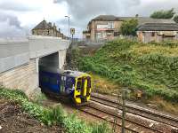 A slightly delayed Edinburgh - Glasgow service passes under the new Station Road overbridge opened to traffic a few days previously. Some landscaping and tidying work remains to be done on the east side, while on the station side the platform 1 pedestrian steps and ramp have not yet reopened.<br><br>[Colin McDonald 18/08/2017]