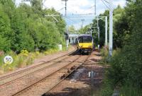 318252 approaching Kirkwood station with a Whifflet to Dalmuir sevice on 28th July 2017. The train has just passed the site of Langloan station which closed in 1964<br><br>[Alastair McLellan 28/07/2017]