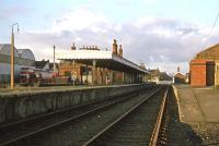 Dereham station at sunset on 11th November 1977, looking north. The passenger service to Norwich had ceased 8 years earlier, but a daily goods train was continuing. In the future lay final closure to goods (1989), dereliction and resurrection by the Mid Norfolk Railway.<br><br>[Mark Dufton 20/11/1977]