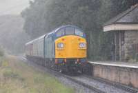 In a sudden downpour, that thankfully was quickly over, 40135 approaches Irwell Vale halt with a five coach train for Rawtenstall on 19th August 2017. The steam heat fitted Class 40 has been based on the East Lancashire Railway since 1988 and recently underwent a body overhaul and repaint into BR Blue. <br><br>[Mark Bartlett 19/08/2017]