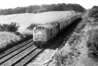 A Summer Saturday train from Blackpool seen between Kirkham & Wesham and Salwick stations behind Brush Type 2 31293 on 7th August 1982. The former D5826 was built in 1961 and would last in service until 1990 before being scrapped at Stratford in 1994. <br><br>[Mark Bartlett 07/08/1982]