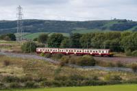 A 314 passes the site of Lyoncross Junction. The Barrhead and Paisley route was in the trees behind the train.<br><br>[Ewan Crawford 14/09/2017]