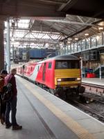 The unusual sight of a Class 91 hauling 'astern' has attracted a (very)<br>
small crowd - unless they were just hanging about anyway. 91 127 is the<br>
loco; presumably the one behind it had failed. The 1700 to London KX is the train, seen on 14 September.<br>
<br>
<br><br>[David Panton 14/09/2017]