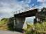 Half a mile to the east of Strichen the railway crosses a minor road. The bridge looks quite precarious but at least it survived unlike many on the route. This is now part of the Formartine and Buchan Way.<br><br>[Alan Cormack 15/08/2017]