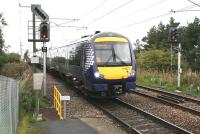 ScotRail 170477, forming the Sunday 1011 Edinburgh - Tweedbank service, about to arrive at the platform at Newcraighall on 17 September 2017. The freight line to Millerhill runs past on the right and the 'feathers' on the signal are for the Niddrie South - Niddrie West freight-only route.<br><br>[John Furnevel 18/09/2017]
