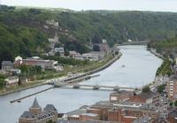 A view from the ramparts of Dinant Citadel, towards another castle on the far bank. A SNCB Class 08 Desiro EMU runs alongside the River Meuse as it approaches Dinant from Namur on 6th September 2017. The Meuse carries a significant amount of commercial and pleasure traffic and there are a succession of locks and weirs like the one seen here. <br><br>[Mark Bartlett 06/09/2017]