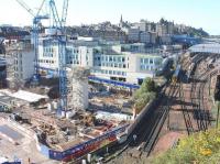 After many years of delays due to planning objections, design revisions, additional consultations, archaeological digs, a recession, etc, etc... work on Edinburgh's famous 'Waverley Valley' gap site is now well underway. View is west on 5 October 2017, with the Edinburgh Council HQ on the other side of New Street. In the right background, heading into Waverley platform 8 from the Calton Tunnel, is the 1029 ex-Tweedbank.<br><br>[John Furnevel 05/10/2017]