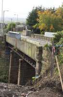 Only now revealed from this angle during the preparatory works for its replacement, the Muirhead Road overbridge at Baillieston station seen in October 2017. <br><br>[Colin McDonald 10/10/2017]