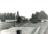 A Kilmarnock - St Enoch train runs through the remains of the southbound platforms of Gorbals station on 20 July 1961. At the head of the train is Hurlford shed's BR Standard class 4 tank 80111.<br><br>[G H Robin collection by courtesy of the Mitchell Library, Glasgow 20/07/1961]