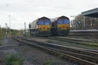 A pair of EWS Class 66s sit in the sidings next to Didcot station on 30 October 2010 waiting for their next working. [Ref query 21 October 2017]<br><br>[John McIntyre 30/10/2010]