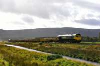 Freightliner liveried 66524 leads a train of loaded ballast wagons for Inverness at Moy on 10th October 2017. 66545 was bringing up the rear.<br>
<br>
<br><br>[John Gray 10/10/2017]