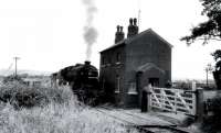 Black 5 45449 waits for the gates at Nateby Crossing Lane to be secured before continuing with a trip working to Pilling in the early 1960s. 1963 saw the closure of the line between Garstang Town and Pilling but the crossing cottage survives in 2017 [See image 18317] although its future is now less certain as the land between here and the A6 has been approved for housing development. <br><br>[Knott End Collection //]