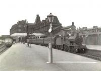 Scene at Ayr station on 25 July 1960. A Glasgow bound DMU calls at platform 3, while a Kilmarnock train waits in bay platform 1. The locomotive is Hurlford 2P 4-4-0 40642. <br><br>[G H Robin collection by courtesy of the Mitchell Library, Glasgow 25/07/1960]
