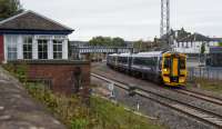 View south to Larbert showing electrification masts between the platforms, the old station building above the train and signal box to left.<br><br>[Ewan Crawford 08/10/2017]