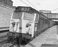 On Saturday 4th of May 1974, the last day of Class 50 hauled services to London Euston from Glasgow before the electric hauled Class 87s, 50045 is seen at Motherwell. A Central SMT Lodekka bus is on the overbridge ... and no, I didn't get the driver to adjust tops to suit me (IM)!<br><br>[Ian Millar 04/05/1974]