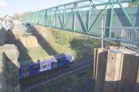 A Dalmuir - Motherwell service passes under the recently installed temporary bridge at Baillieston. 3 months have been allowed to complete the diversion of services over it before the present weak road bridge is demolished. <br><br>[Colin McDonald 02/11/2017]