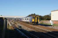 A Northern Class 150 and Class 156 on a Blackpool to Huddersfield service pass the biscuit factory (right) in Kirkham on 27 October 2017.<br><br>[John McIntyre 27/10/2017]