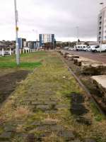 Although all traces of Granton Harbour station are long gone some track remains here on the middle pier. The station platform was where the roadway now is. The<br>
area is now residential, the western part of the harbour (right) having mostly been filled in.  Looking south on 31st October 2017.<br>
<br>
<br><br>[David Panton 31/10/2017]