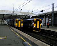 A delayed Stranraer service (right) changes crew at Ayr on 10 October. The train on Platform 3 (left) is not a northbound service but will form the next one southbound, to Girvan, in about 45 minutes.<br><br>[David Panton 10/10/2017]