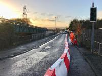 Preparations under way for the temporary reopening of the original bridge at Baillieston station. The bridge will close again in February for demolition and replacement.  The plastic barrier sections will require filling with water to ensure they don’t find their way on to the track underneath as has happened recently.<br><br>[Colin McDonald 16/11/2017]