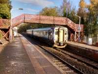An East Kilbride train calls at Giffnock on 11 November 2017. The fine<br>
footbridge would be a casualty of electrification, but it would be a price<br>
worth paying, I think.<br>
<br>
<br><br>[David Panton 11/11/2017]