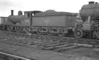 J21 0-6-0 no 65033 standing in the sidings at Heaton shed, buffered up to an accident damaged K3 2-6-0. Photograph thought to have been taken on 26 March 1961.<br><br>[K A Gray 26/03/1961]