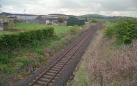 View north at Grangeston Halt. This was a two platform halt just north of Girvan Junctions which served the large ICI Grangeston munitions factory from 1941 to 1965. Two brick built platforms remain intact but the line has been slewed to the centre following reduction to a single track.<br><br>[Ewan Crawford //2002]