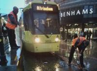The driver of a tram for Altrincham dutifully cleans out flotsam which wild Manchester weather had deposited in the points. My wife, faced with an immobile tram, made a strategic decision to go shopping; we still caught our train home from Piccadilly.<br><br>[Ken Strachan 21/10/2017]