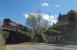 Ex Oban train approaching Crianlarich station on the short spur which links the West Highland to the Callander and Oban. Ahead the narrow bridge where trucks have to take the centre of the road to safely pass under.<br><br>[Beth Crawford 05/05/2017]