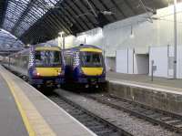 A recently arrived pair of 170 DMUs wait under the wires in Platforms 3 and 2 at Queen Street. In the background, the former Operations Dept is now neatly shrouded in white plastic as the demolition work on the old staff buildings at the west side of the station begins to get under way. Staff are now housed in the temporary buildings alongside Platform 7.<br><br>[Colin McDonald 01/12/2017]