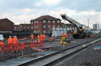 A self-propelled rail crane positions track panels for the workforce in the new station throat at Blackpool North. 9th December 2017. The panels were being unloaded from a nearby road vehicle.<br><br>[Mark Bartlett 09/12/2017]