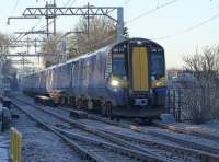 380 114 and 380 104 leave a sub-zero Linlithgow with the 11.00 Glasgow Queen Street service, on the first day of electric operation. <br><br>[Bill Roberton 10/12/2017]