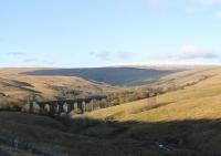 Snow was causing great disruption to the Midlands on 27th December 2017 but not to the highest mainline in England. A Carlisle to Leeds train crosses Dent Head viaduct. Looking back along Dentdale the station can be seen on the hillside in the distance. <br><br>[Mark Bartlett 27/12/2017]