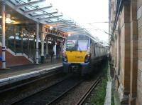 Unusual view looking west between the 'sub' platforms and the south wall at Waverley on 21 December 2017, showing ScotRail 334025 leaving platform 9 (W) with the 1107 service to Mingavie. Photographed through a glass panel at the base of the passenger access stairway serving platform 10. <br><br>[John Furnevel 21/12/2017]
