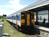 Train and passenger waiting in the sunshine at Falmouth Docks station in the summer of 2002. Wessex Trains 150246 forms the 1320 service to Truro. <br><br>[Ian Dinmore 12/06/2002]
