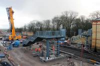 The footbridge for the new third platform at Kirkham being installed, with the help of a huge Ainscough crane, on 18th January 2018. The main bridge span was installed that same evening but the station is scheduled to reopen for Blackpool South line services on 29th January 2018 so there is still plenty for the <I>Orange Army</I> to do. [See image 59693] taken six months earlier showing the transformation of this location. <br><br>[Mark Bartlett 18/01/2018]