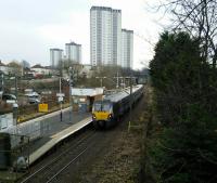 The tower blocks of Scotstounhill seem to be advancing on Garscadden<br>
station as a Dumbarton Central service calls on 13th January 2018.<br>
<br>
<br><br>[David Panton 13/01/2018]