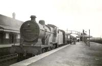 A train from Dumfries calls at Mauchline on 18 April 1949 on its way to St Enoch. The locomotive is one of Hurlford shed's 2P 4-4-0s, no 40663. <br><br>[G H Robin collection by courtesy of the Mitchell Library, Glasgow 18/04/1949]