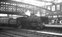 One of Kingmoor shed's Ivatt class 4MT 2-6-0s, no 43000, standing alongside platform 4 at Carlisle on 11 April 1964. The locomotive has recently arrived with the 10.48am Saturday morning local service from Langholm.<br><br>[K A Gray 11/04/1964]