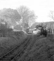 Looking east at Leslie in 1966 along the line serving Fettykil Paper Mill, with the east sidings of Leslie goods yard at a slightly higher level on the left. The train approaching over Glenwood Road level crossing is the returning trip from the mill, in the hands of  Thornton shed's J38 0-6-0 no 65915. Passenger services to Leslie had ceased in 1932 but the branch survived for goods traffic until 1967. [See image 24804] <br><br>[Robin Barbour Collection (Courtesy Bruce McCartney) //1966]