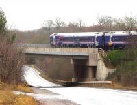 ScotRail 158739 crossing a deserted A7 as it approaches the Gorebridge stop on a grey and overcast first day of February 2018. The train is the 1154 Edinburgh - Tweedbank.<br><br>[John Furnevel 01/02/2018]