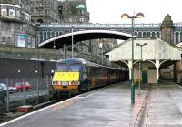The recently arrived empty stock which will form the GNER 0900 service to Kings Cross stands at Waverley platform 21 early on a wet Sunday morning in September 2004. It would be another 8 years before work finally got underway on a replacement canopy for the 'sub' platforms [see image 43131]. <br><br>[John Furnevel 05/09/2004]